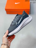 Side view highlighting the dark upper, white side logo, sculpted white midsole, and low-top profile.
