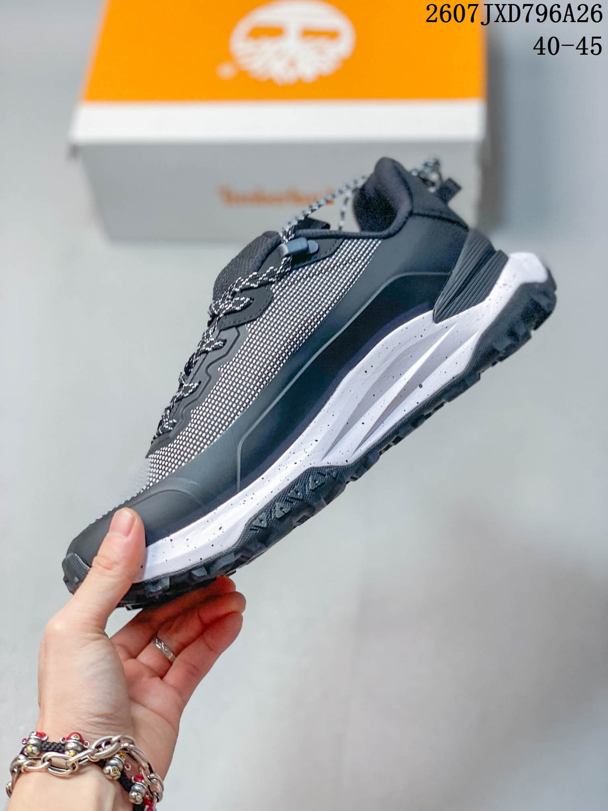 Side profile showing the mesh-look upper, lace system, dark overlays, and layered white midsole.