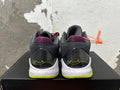 Rear view of black and burgundy Nike basketball shoes with a speckled white midsole and bright yellow-green outsole.
