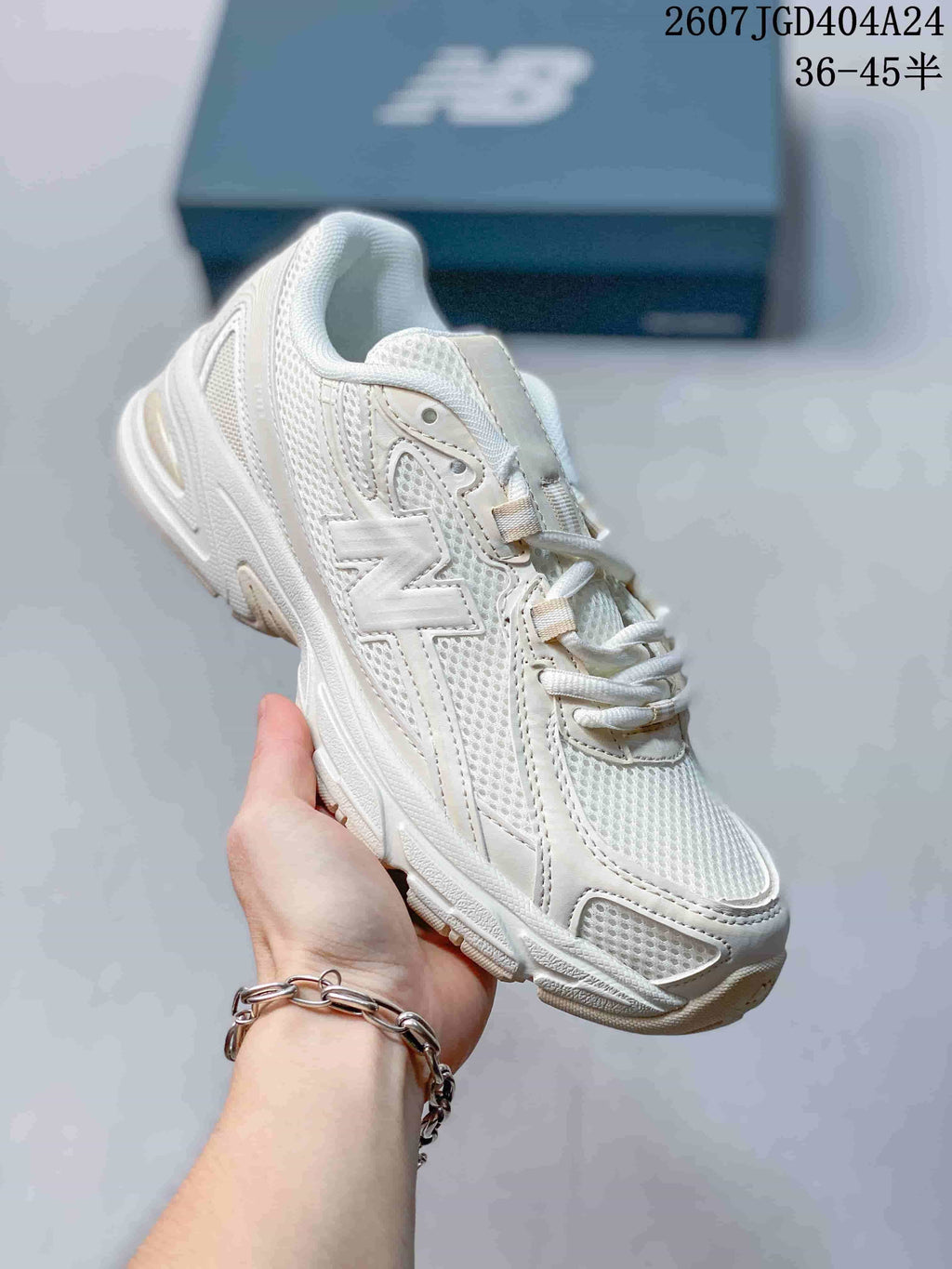 Angled side view of the beige New Balance 740 sneaker with the New Balance logo visible.