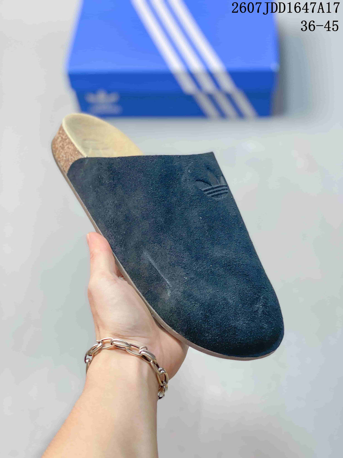 Angled view of a single black adidas Adimule slide showing the covered upper, beige footbed, and side profile.