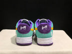 Rear view of the pair showing purple heel panels, mint green uppers, white heel graphics, and Bape Sta branding.