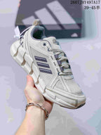 Angled side view of the Adidas Climacool sneaker showing the mesh upper, navy accents, and sculpted outsole.