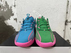 Front view of the blue-and-pink and green-and-pink mismatched basketball shoes