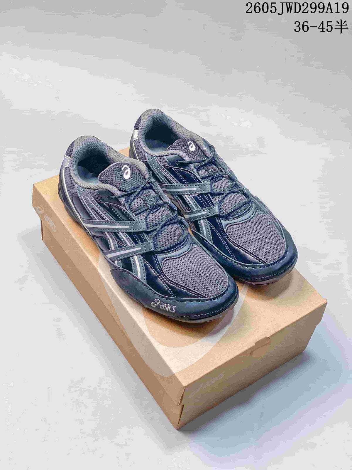 Dark navy ASICS GEL-1130 sneakers displayed on a shoebox.