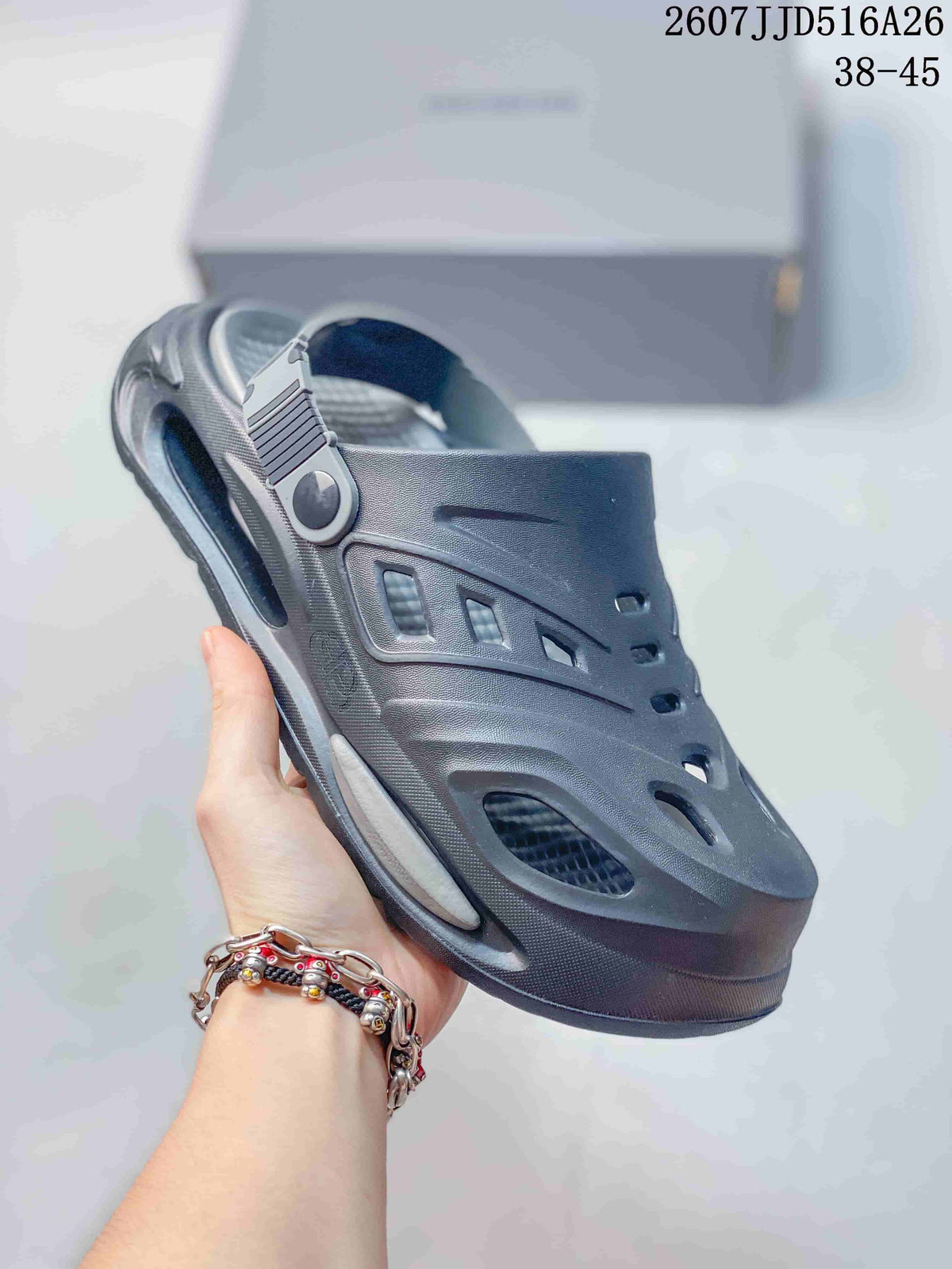 Angled close-up of a dark gray platform clog showing the ventilation openings, heel strap, and raised sole.