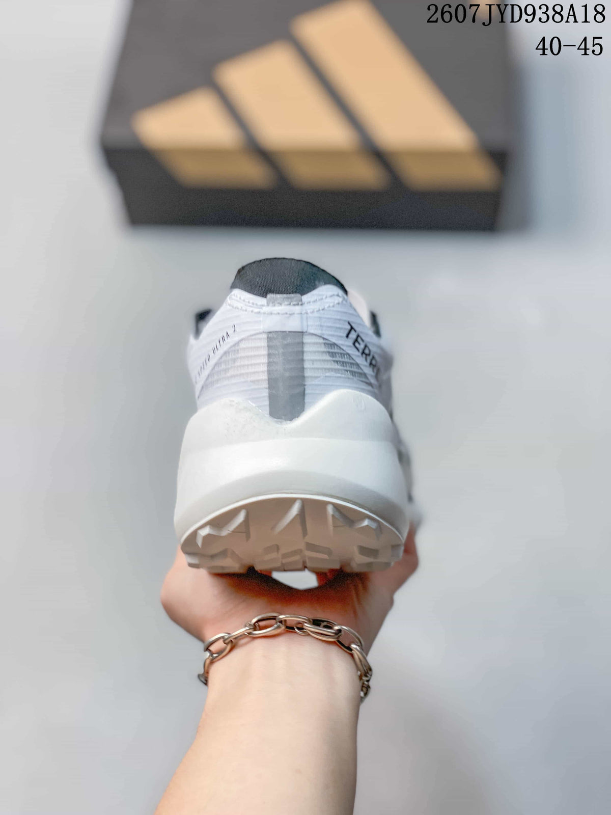 Rear view of the shoe showing the padded heel, white midsole and textured outsole.