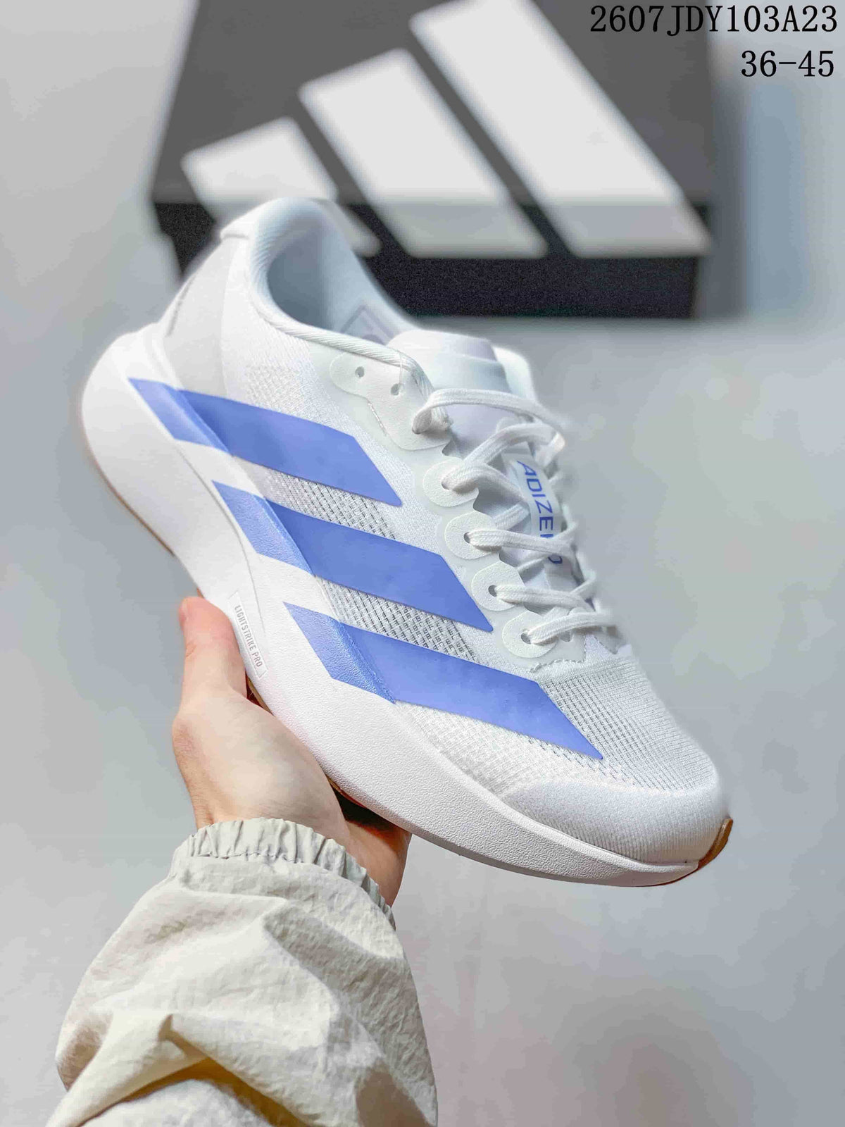 White adidas Adizero low-top sneaker with blue side stripes.