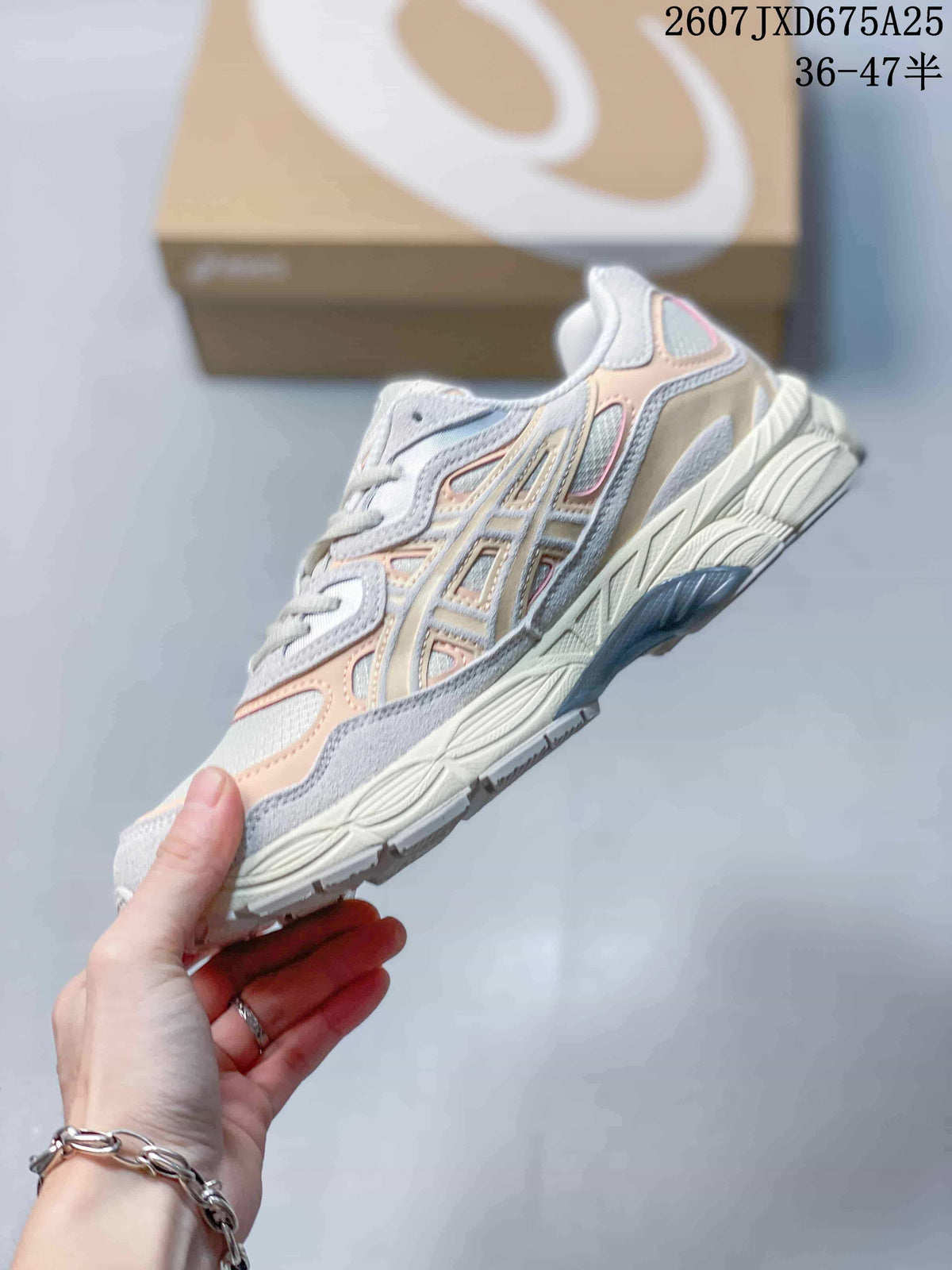 Side profile of a white, grey and peach ASICS GEL-NYC sneaker with layered overlays and sculpted midsole.