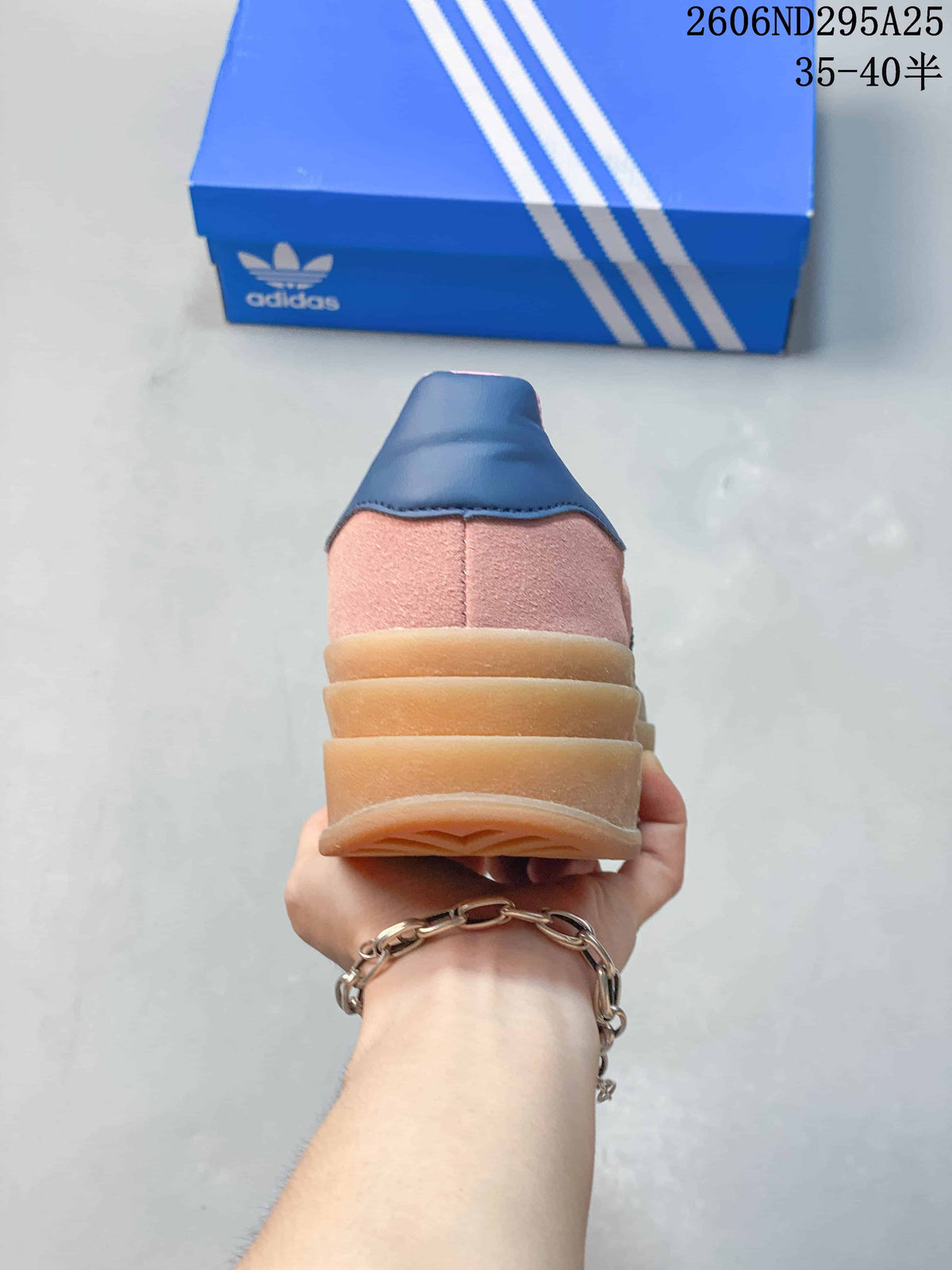 Rear view showing the pink heel panels, navy heel tabs, and stacked gum platform sole.