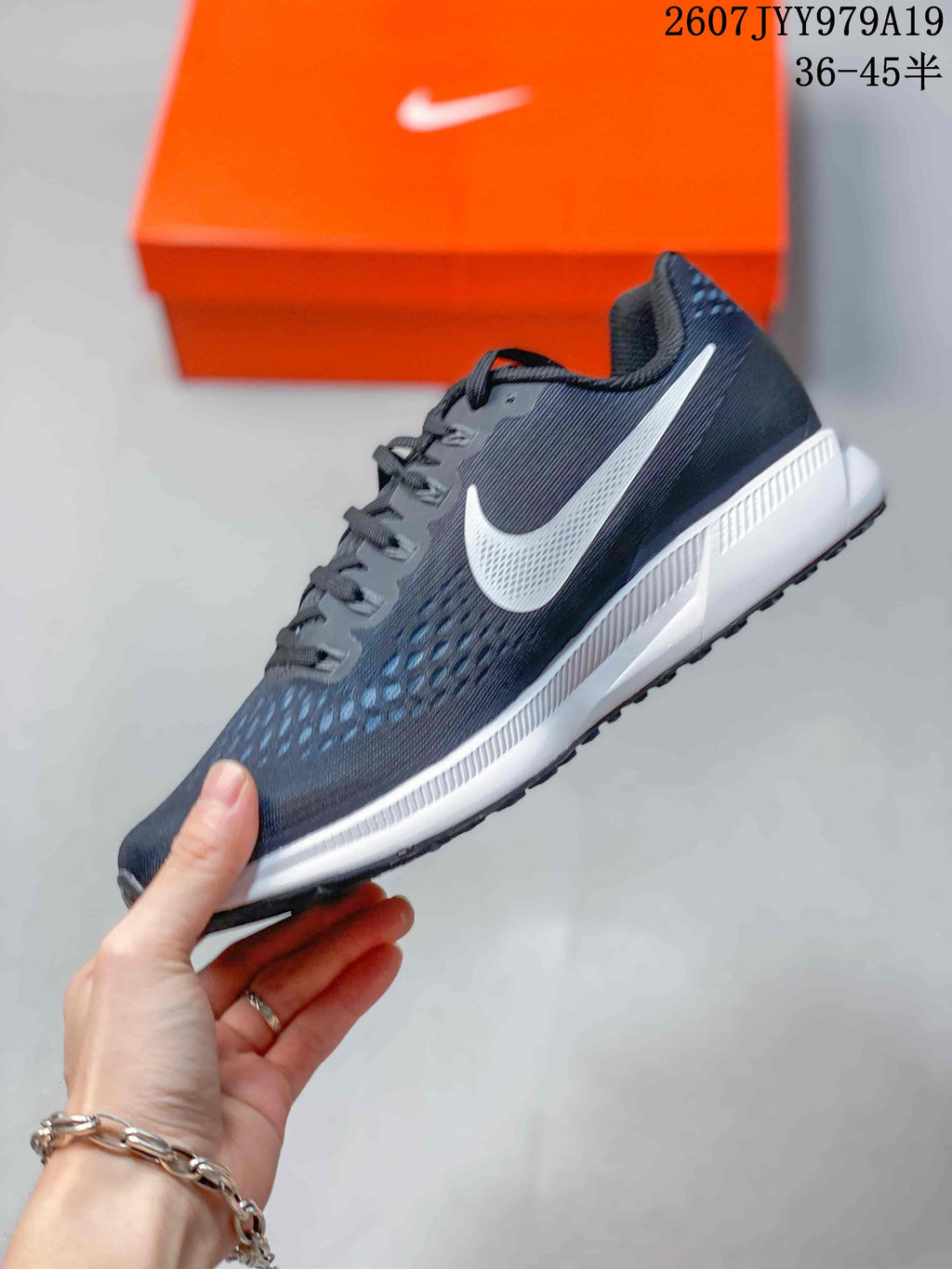 Side profile showing the white Swoosh, dark mesh upper and layered white-and-gray sole.