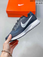 Side profile showing the white Swoosh, dark mesh upper and layered white-and-gray sole.