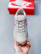 Top view showing the lace-up construction, mesh-textured upper, and pink tongue branding.