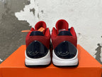 Rear view of red, navy, and white Nike Kobe basketball shoes with signature heel details