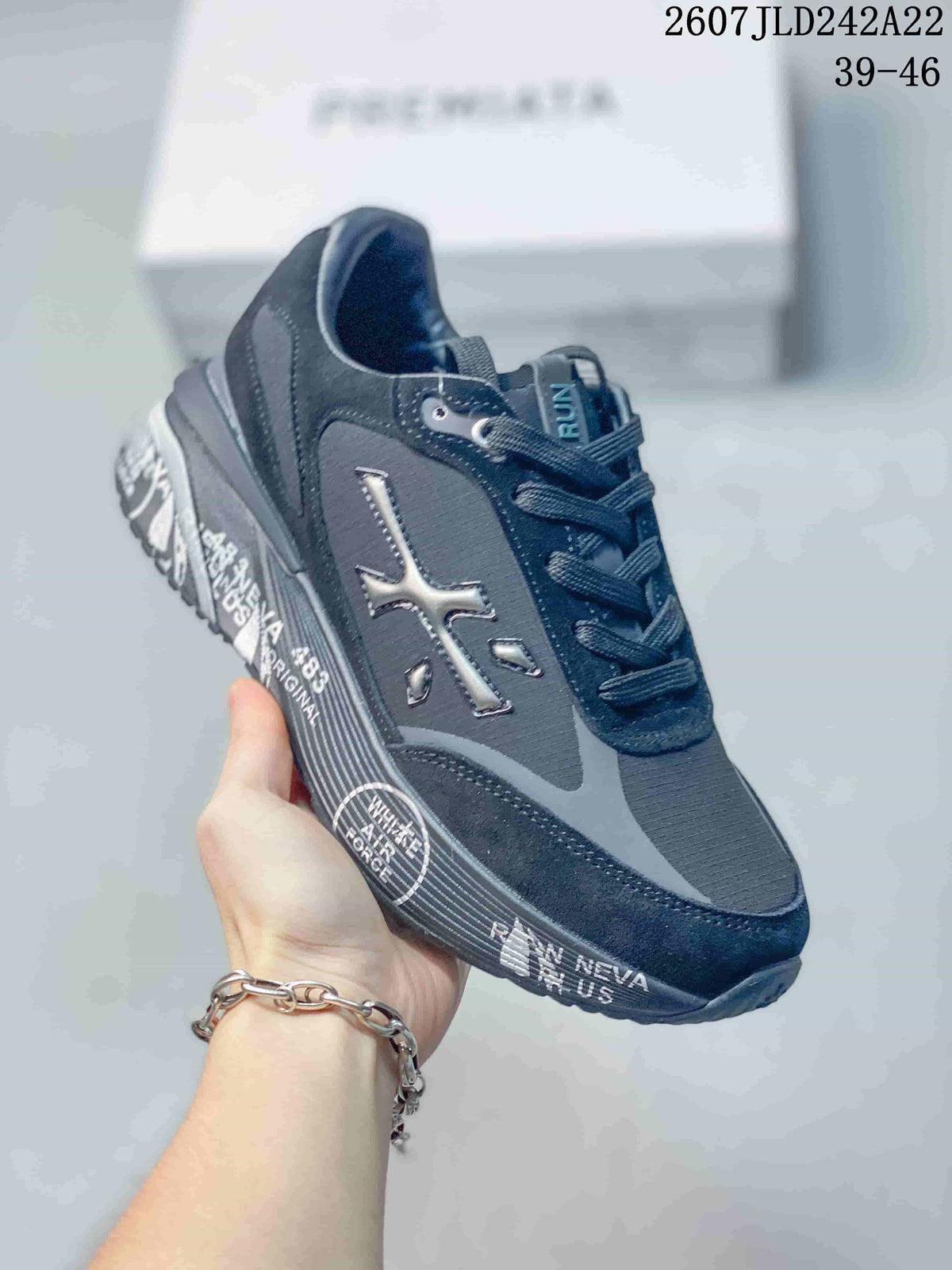Three-quarter side view showing the metallic side emblem, graphic detailing, layered upper, and textured sole.