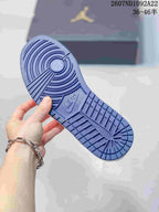 Close view of the blue rubber outsole showing its circular and segmented traction pattern.