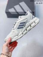 Side view of the sneaker showing the mesh upper, structured support panels, navy stripes, and segmented sole.