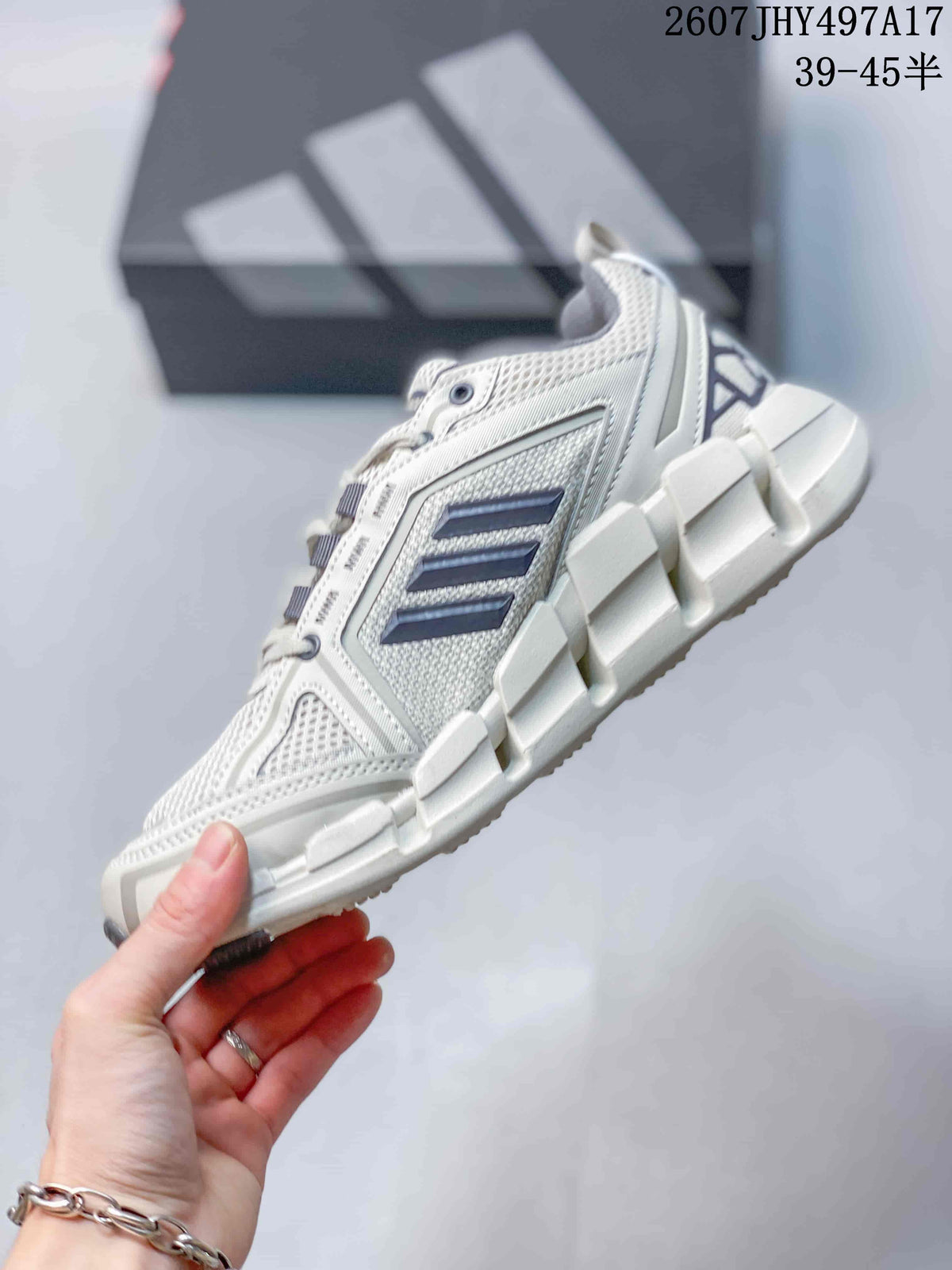 Side view of the sneaker showing the mesh upper, structured support panels, navy stripes, and segmented sole.
