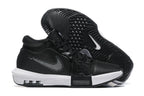 Black low-top basketball shoes with white accents, shown from the side and outsole.