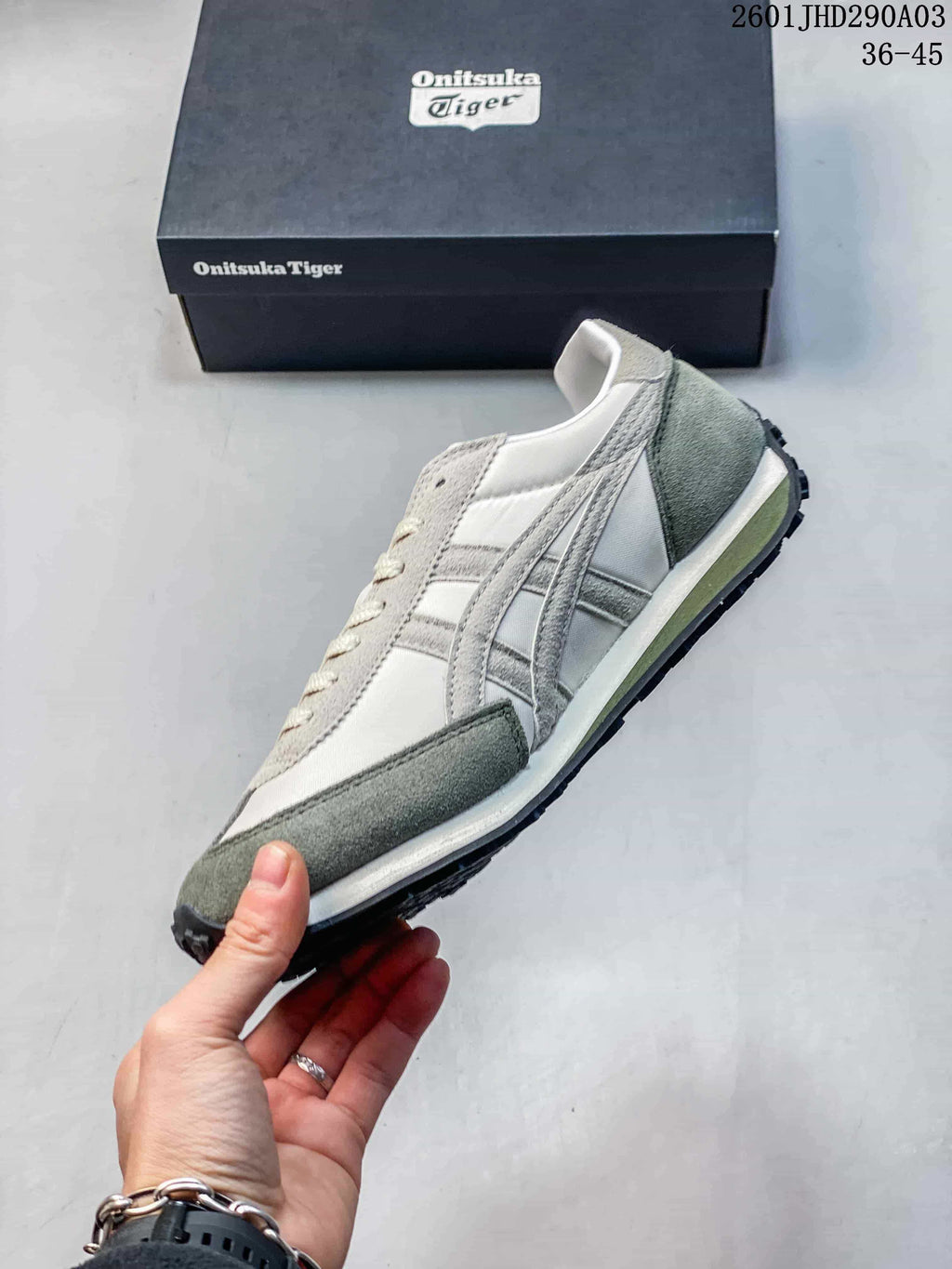 Side profile of the Onitsuka Tiger sneaker showing layered side stripes, contrasting panels, and the low-top shape.