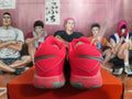 Rear view of red and gray Nike basketball shoes with black accents