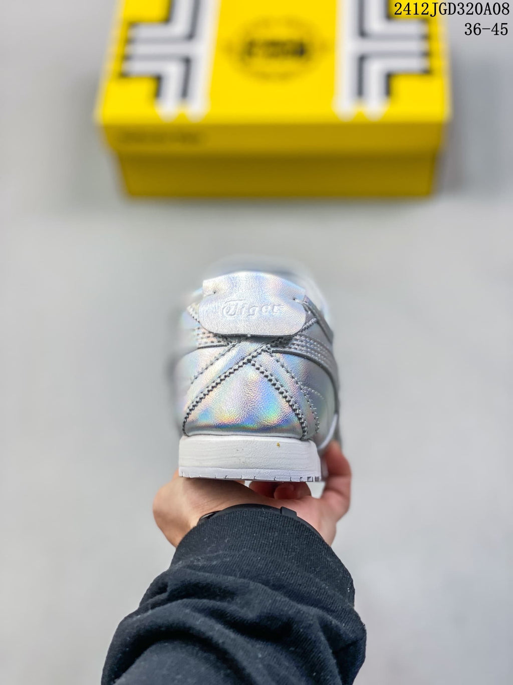 Rear view of the silver iridescent sneaker showing the heel counter, stitching and white sole.