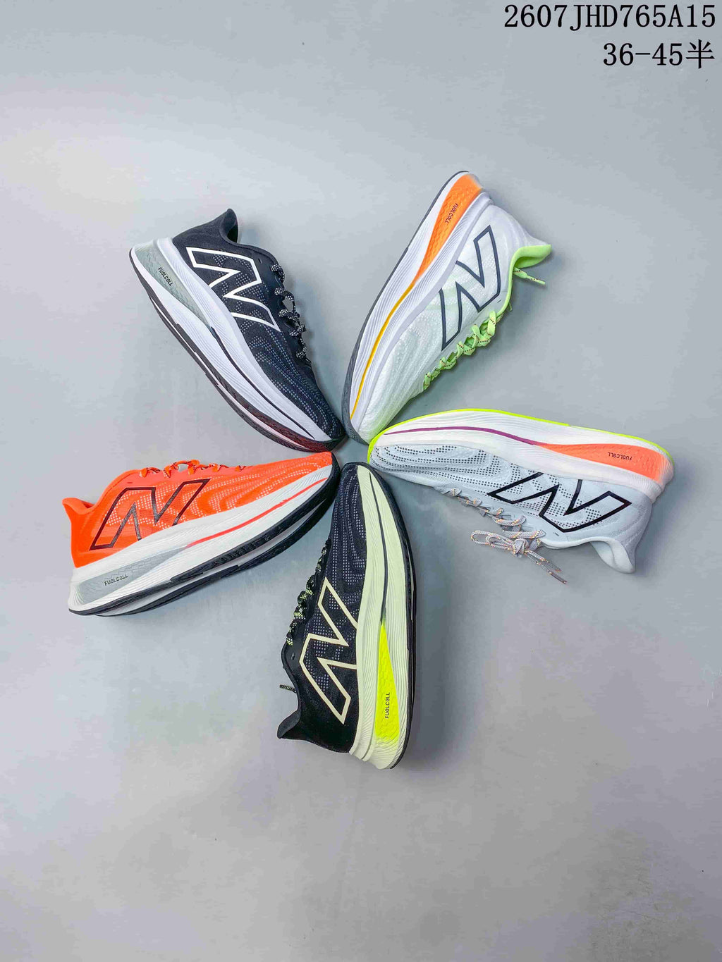 Overhead view showing five New Balance running sneakers in white, orange, dark, and green-accented colorways.