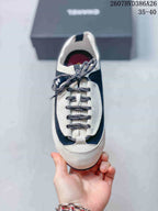 Top view of a single sneaker showing the rounded toe, patterned laces, and contrasting upper panels.