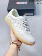 Angled side view of a white ECCO sneaker showing perforated panels, flat laces and the translucent outsole.