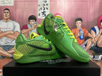 Pair of green Nike basketball shoes with black Swoosh logos and bright yellow-green laces.