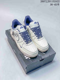 Pair of white and blue Nike Air Force 1 '07 low-top sneakers displayed on a shoebox, with style code and size range text above.
