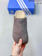 Front view of the clog showing the closed rounded toe, light footbed, and tonal adidas Trefoil branding.