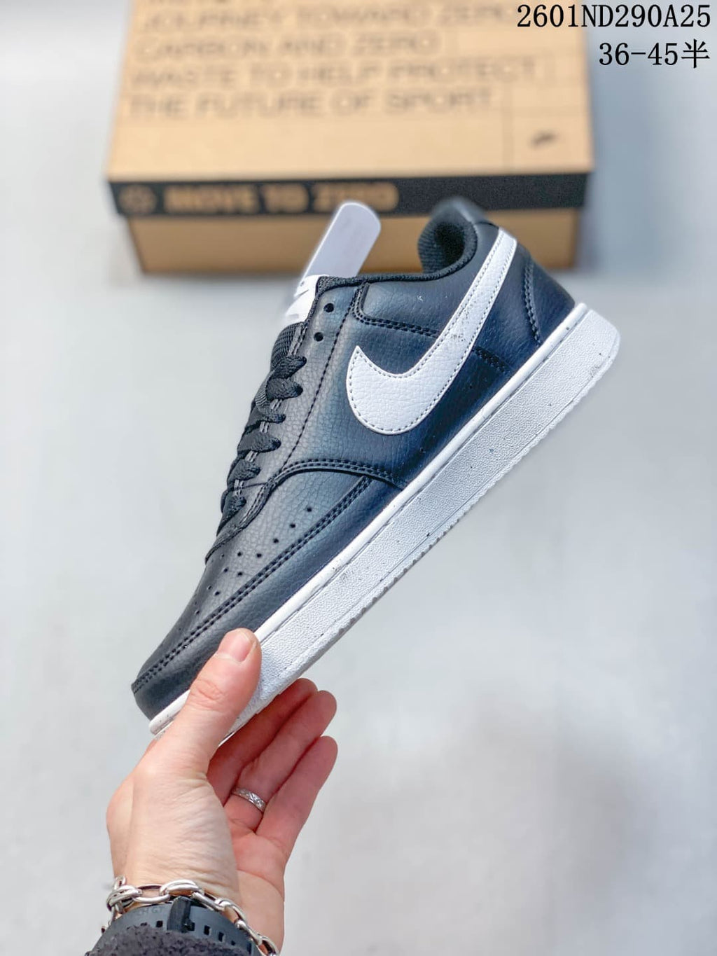 Side profile showing the navy low-top sneaker, white Swoosh, perforated toe area, and white sole.