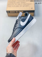 Side profile showing the navy low-top sneaker, white Swoosh, perforated toe area, and white sole.