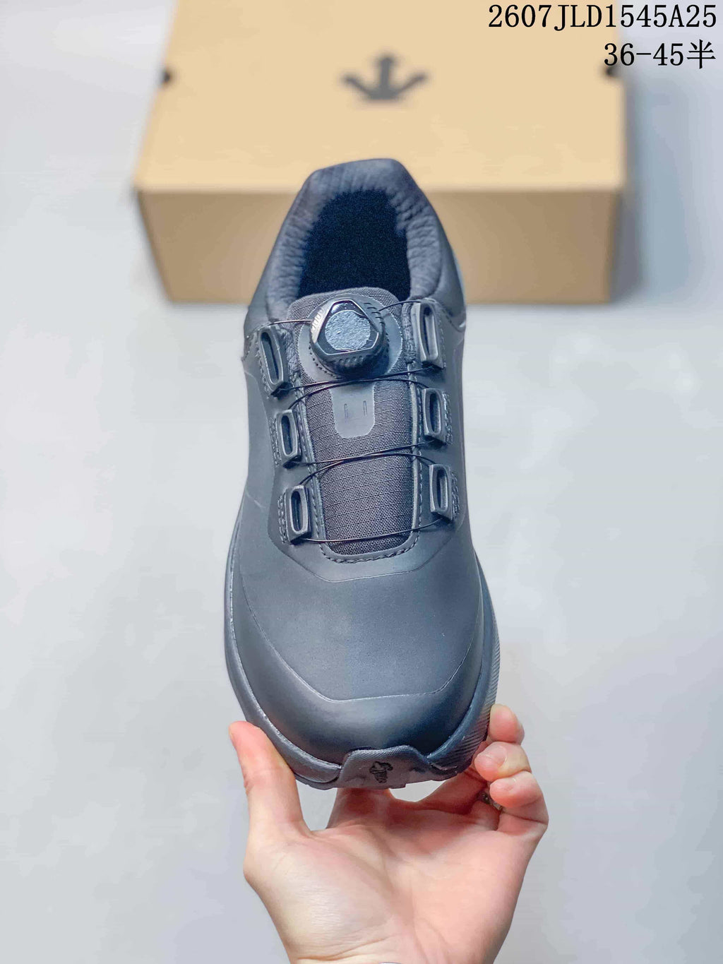 Top view of the black sneaker showing the dial-style fastening, tongue and rounded toe.