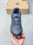 Top view of the black sneaker showing the dial-style fastening, tongue and rounded toe.