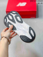 Outsole view showing black and white segmented tread areas on a New Balance shoe.