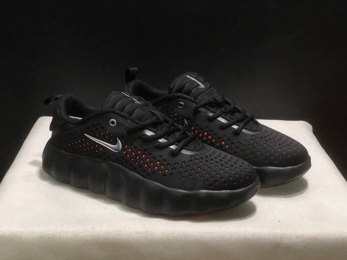 Three-quarter view of the pair highlighting the black perforated uppers and silver-colored side logos.