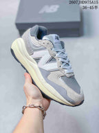Gray and off-white New Balance 5740 sneaker shown from a front three-quarter view.