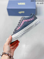 Side profile showing the dark navy upper, multicolor patterned side stripe, white sole and low-top silhouette.