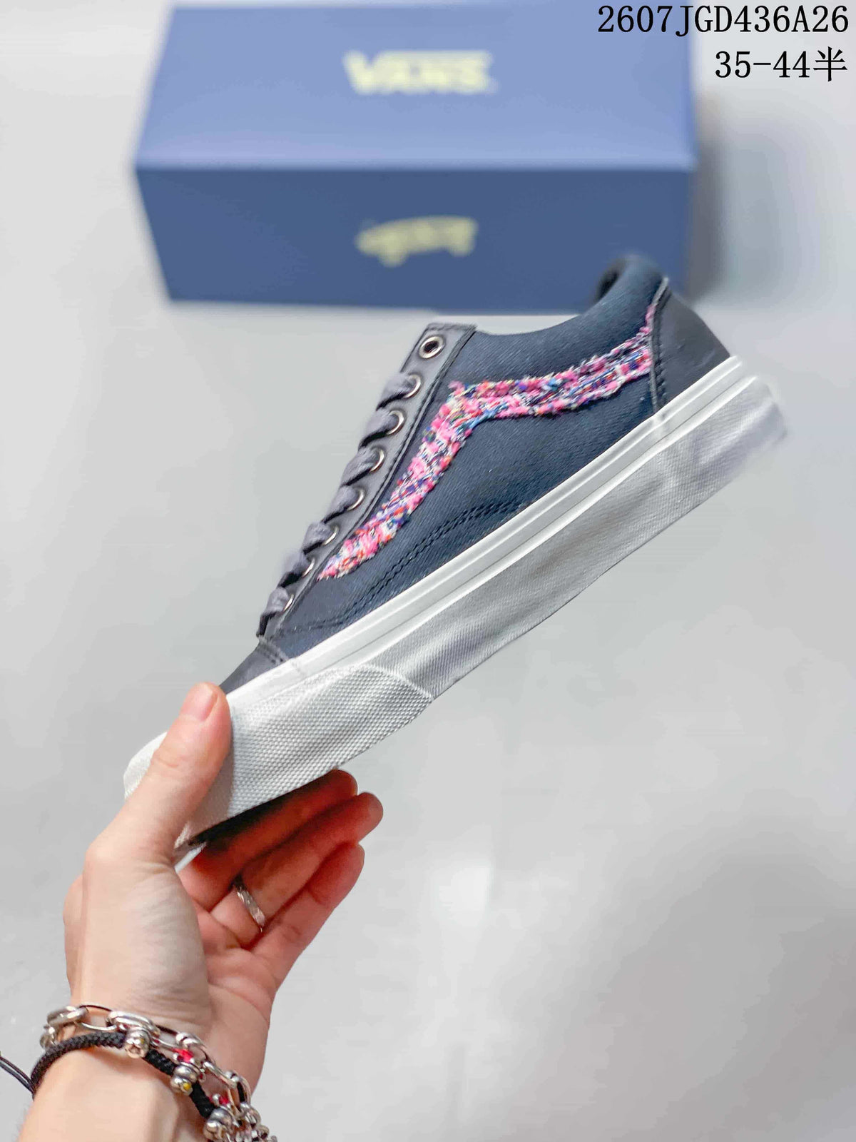 Side profile showing the dark navy upper, multicolor patterned side stripe, white sole and low-top silhouette.
