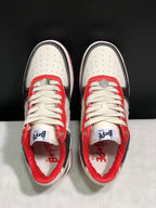 Top-down view showing perforated white toe boxes, cream laces, red lace panels, and branded insoles.