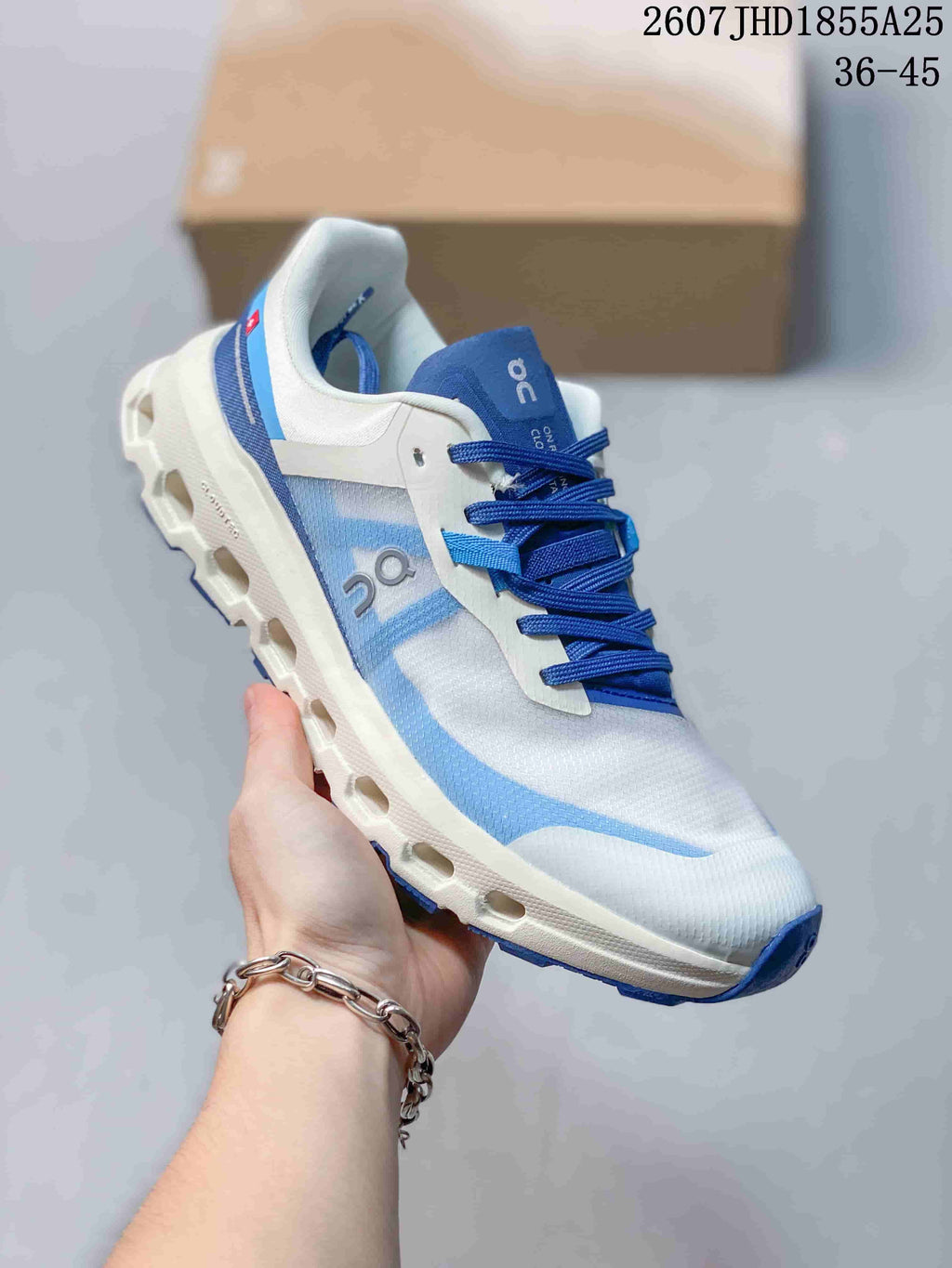Three-quarter side view of the white and blue On Cloudvista 2 sneaker showing the lace-up upper, side branding, and lugged outsole.