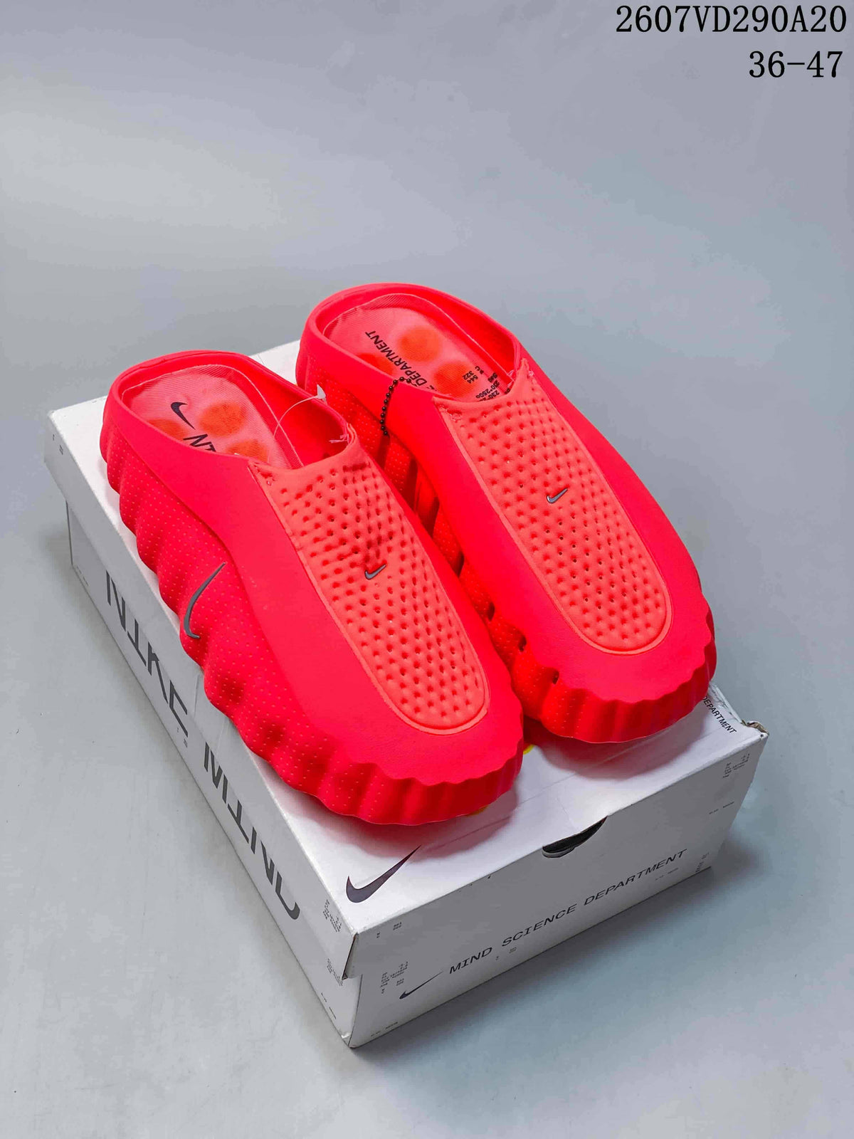Pair of bright red Nike Mind 001 slides displayed on a Nike Mind shoebox.