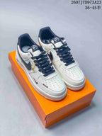 Pair of white and navy Nike Air Force 1 '07 sneakers displayed on an orange box; overlay text shows the code 2607TYD973A23 and size range 36–45.5.
