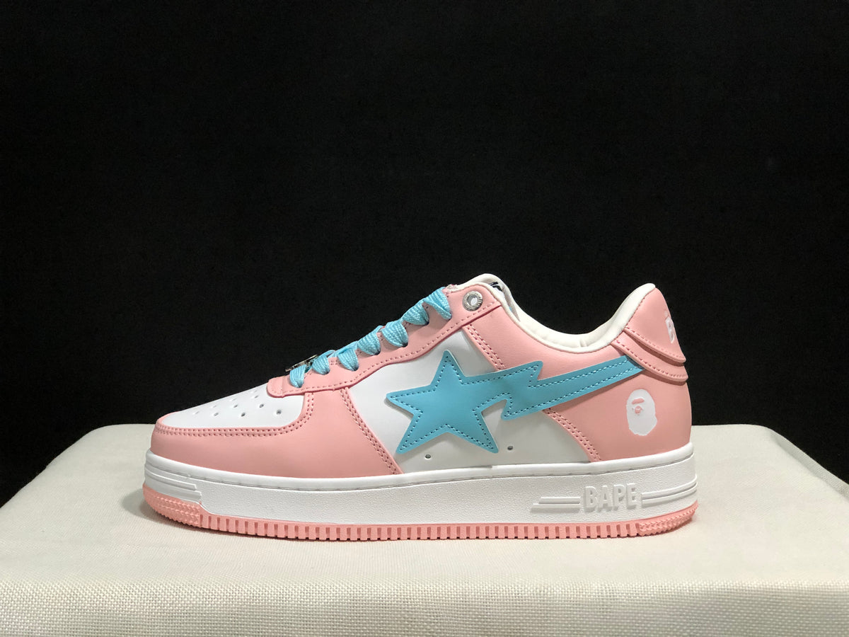Side profile of a pink and white low-top sneaker with a light-blue star-shaped side emblem and pink outsole.