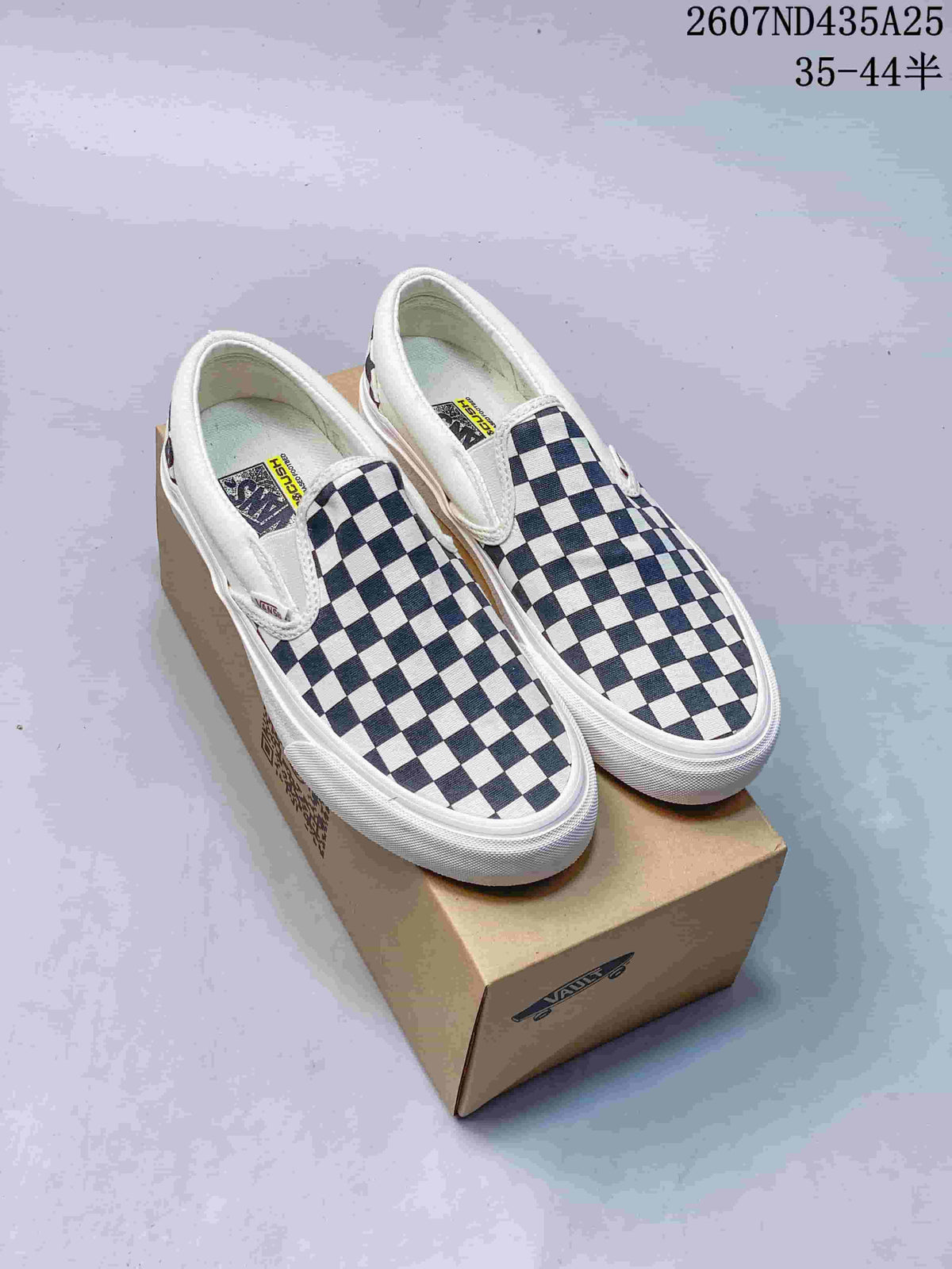 Pair of Vans navy-and-white checkerboard slip-on sneakers displayed on a Vans shoe box.