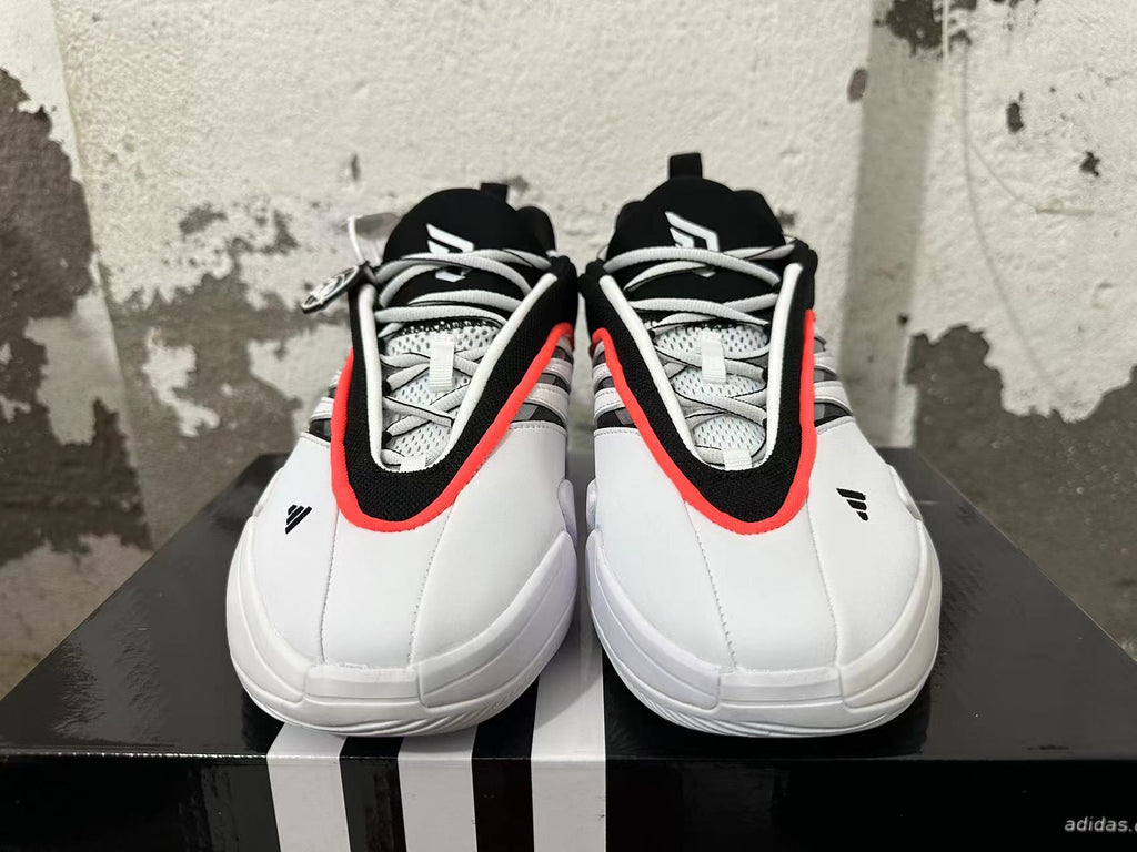 Front view showing the lace-up design and black, white, and red-orange detailing