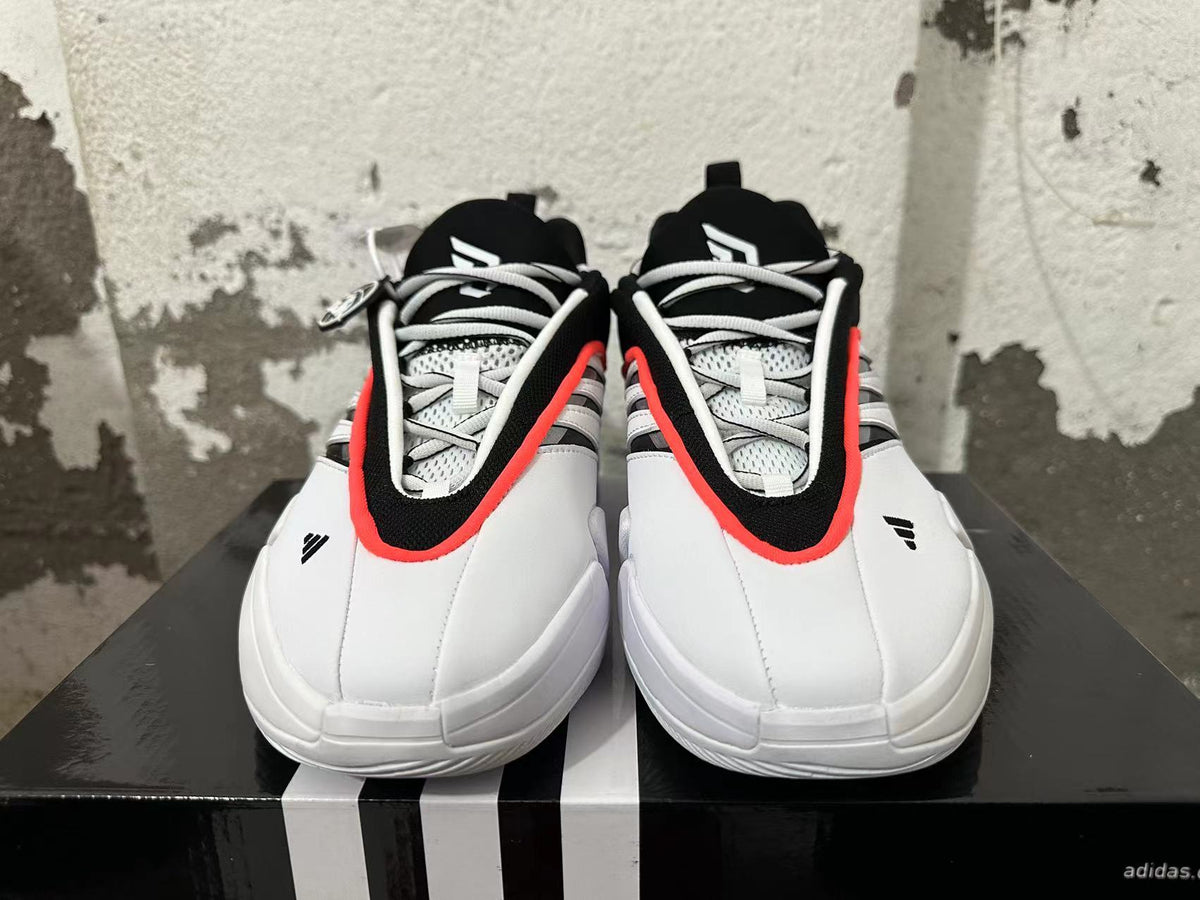 Front view showing the lace-up design and black, white, and red-orange detailing