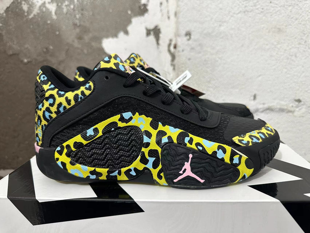 Side view of a Jordan Luka 1 shoe showing patterned panels and pink Jumpman detail